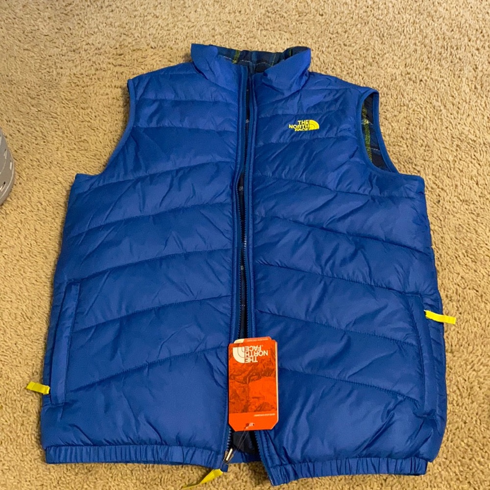 The North Face reversible vest. Size YOUTH XL. Never worn. Retail price:$85